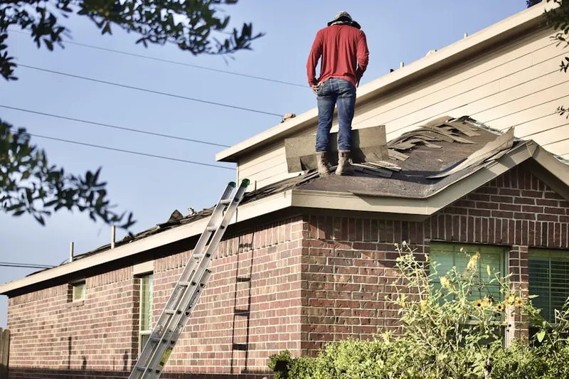 Professional roofer working on a residential roof in Golden City